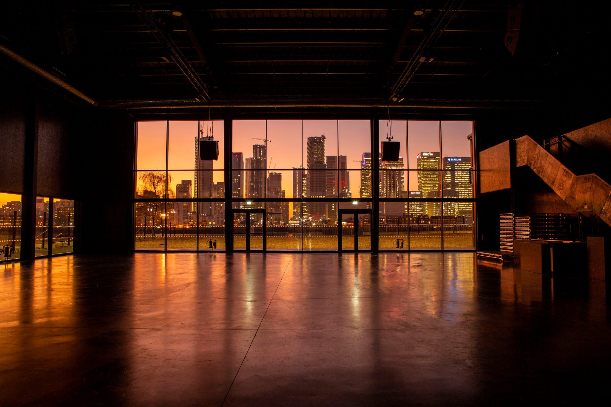 View over a city with skyscrapes in the evening from inside a building