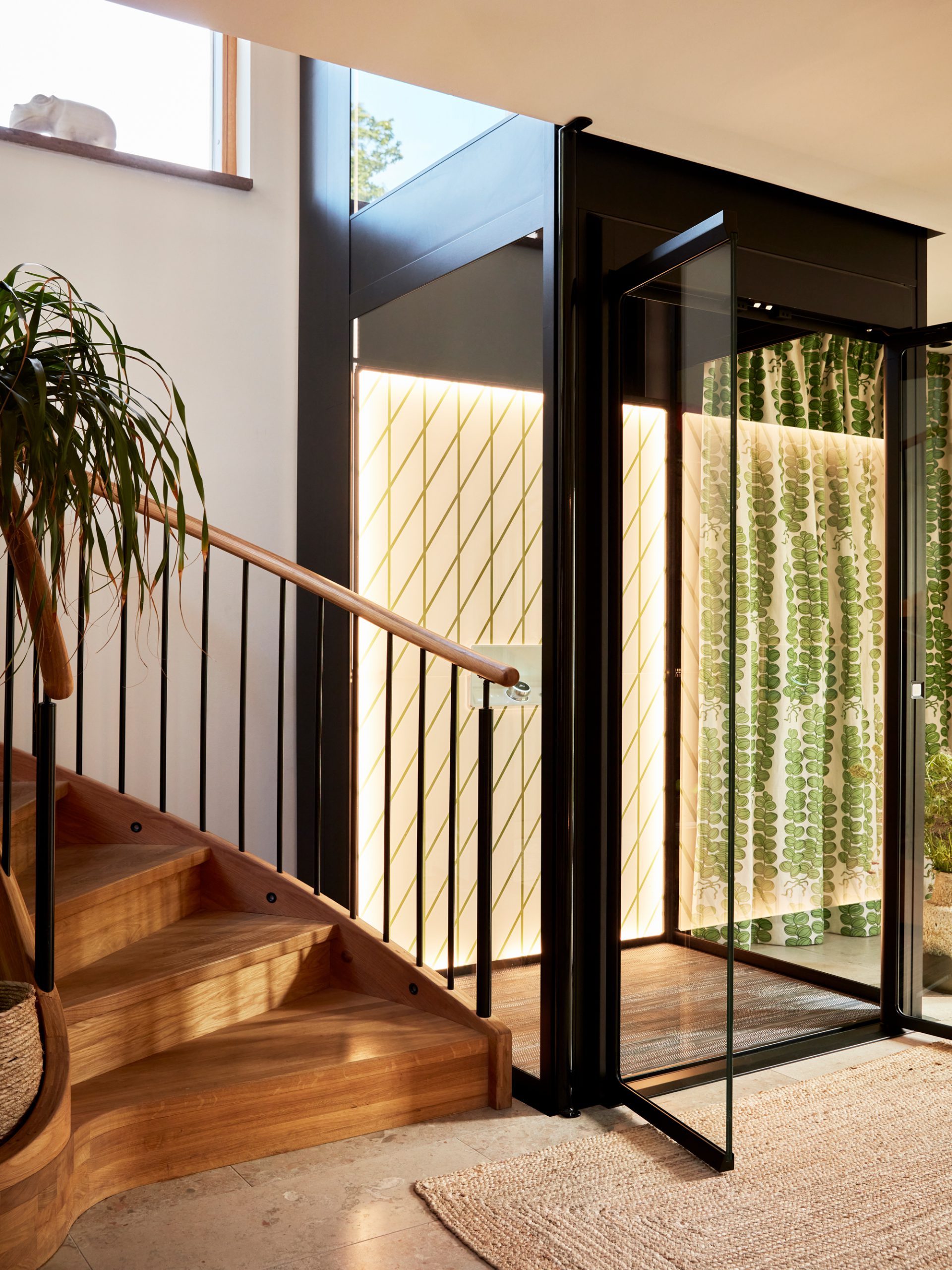 Close up of a home lift by Aritco and stair