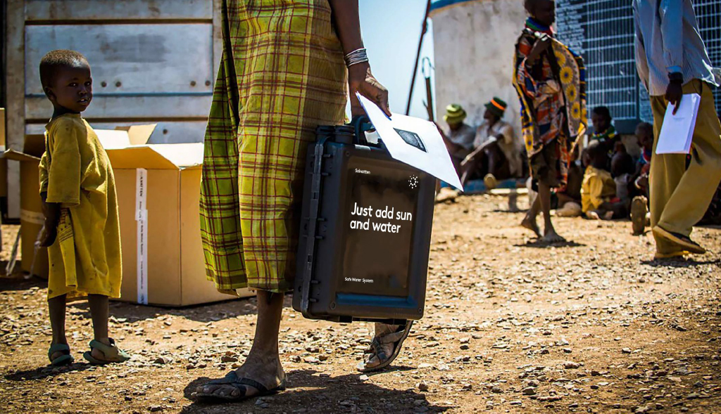 Person carrying box from Solvatten