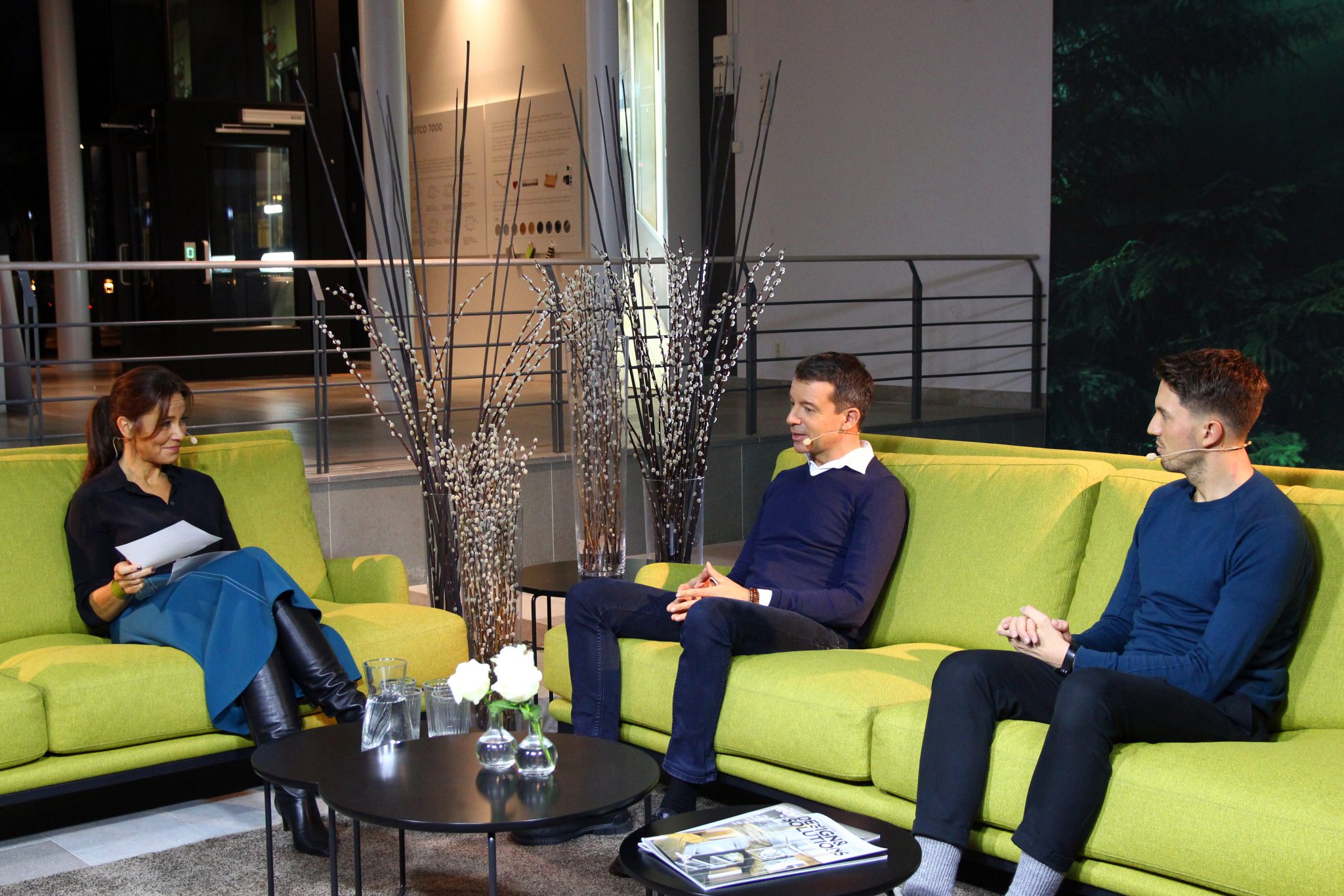 Three persons sitting in a yellow-green sofa