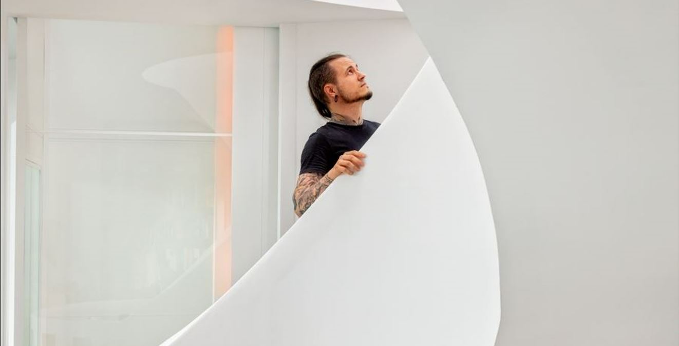 A man walking upstair a white staircase