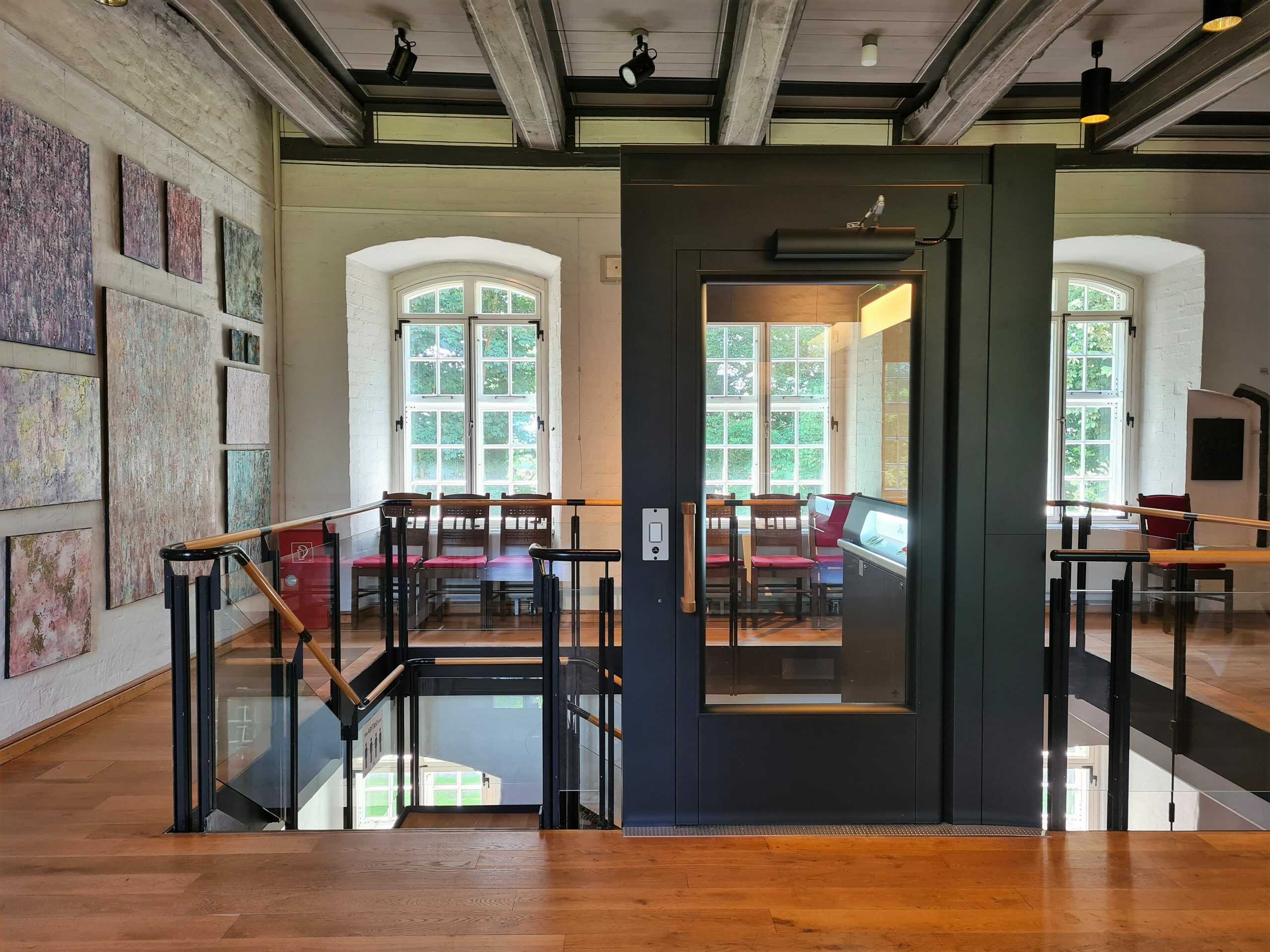 A black Aritco PublicLift Access in the castle Burg zu Hagen Palace, Germany