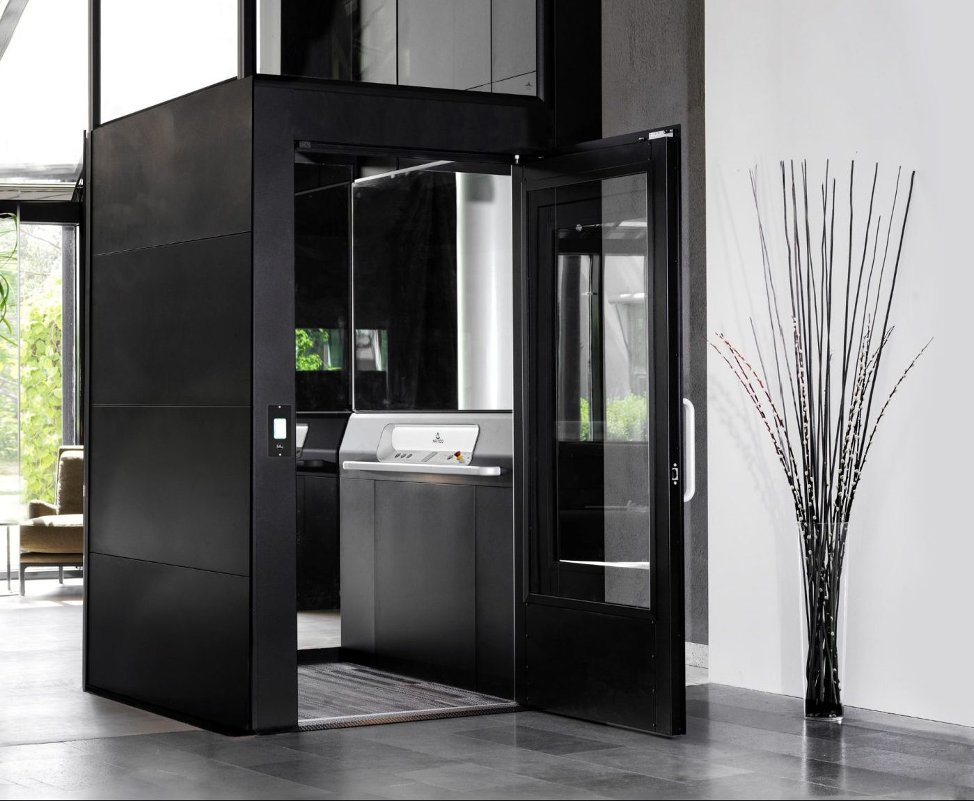 Spacious black home lift, elevator, in living room. Aritco HomeLift Access