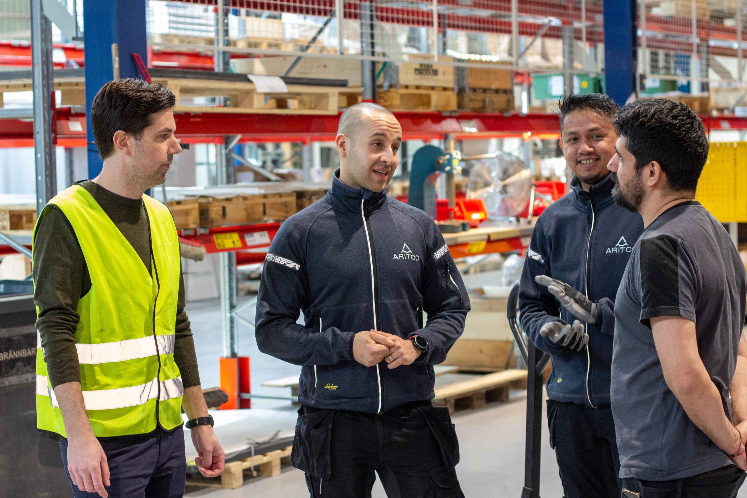 Four men in a production area